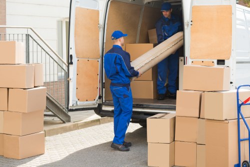 Furniture collection team handling bulky items in a Tooting street