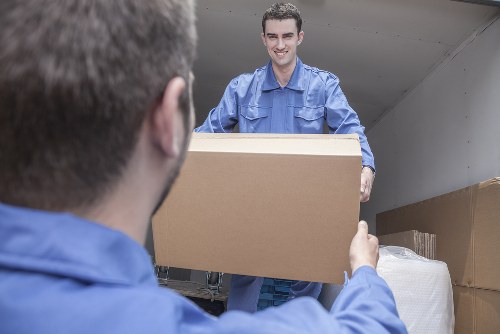 Professional movers handling furniture in a Tooting flat