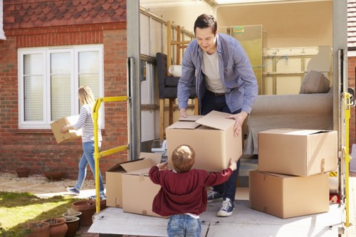 Packed moving boxes and furniture ready for a local move in Tooting